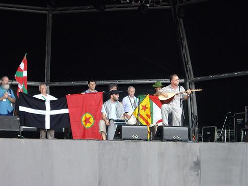 The World Social Forum Stage (above) with John Cutliffe from the Cornish Stannary Parliament with the Cornish flag (second from left)