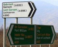 Bilingual road signs in Scotland  shown in different colours.