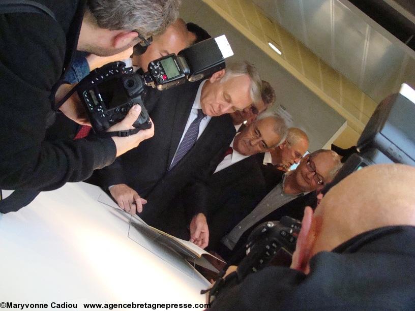 Jean-Marc Ayrault écrivant dans le livre d'or à côté de Bernard Deniaud conseiller général.